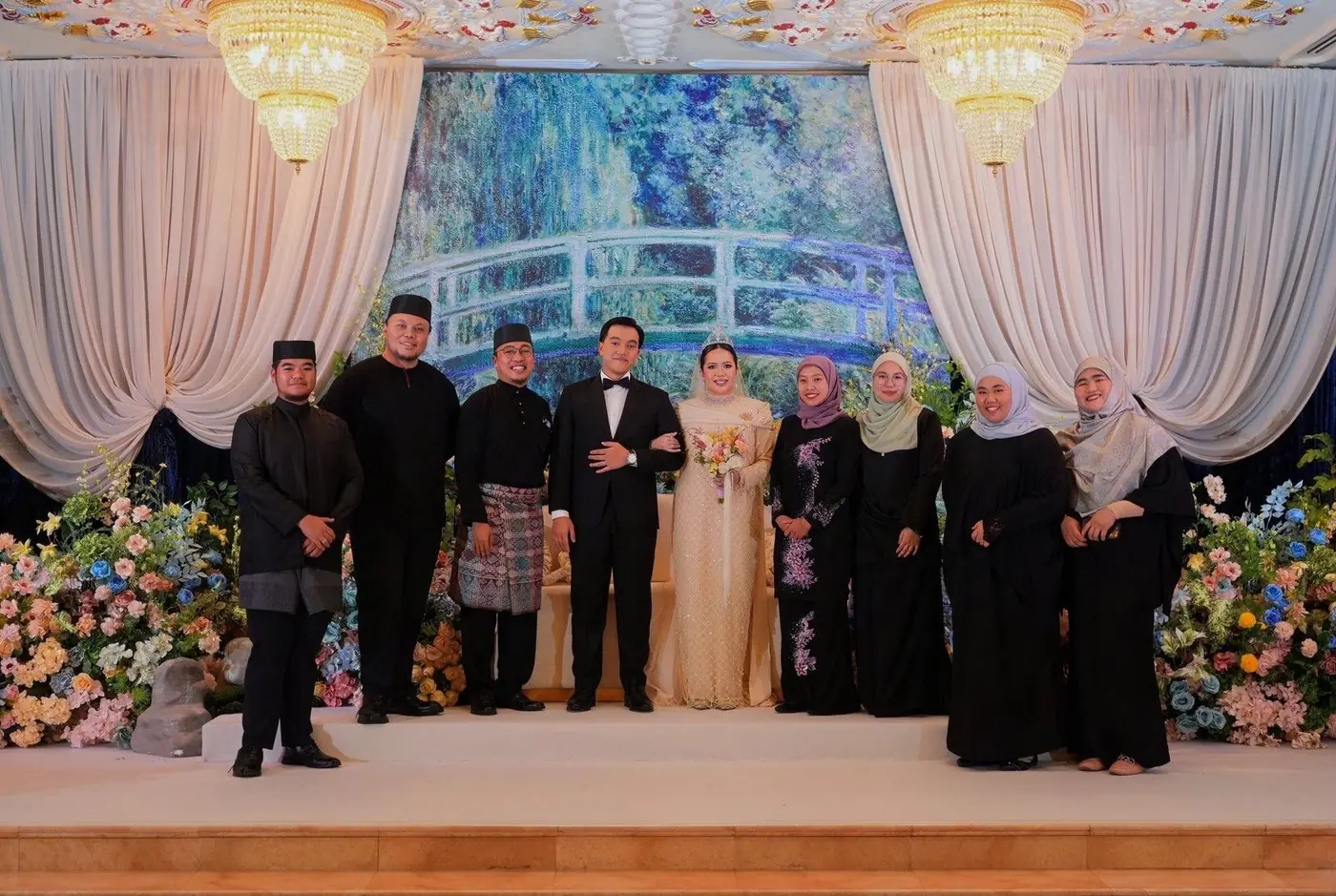 Eight Agendas Brunei crew flanking a couple in a grand hall with chandeliers